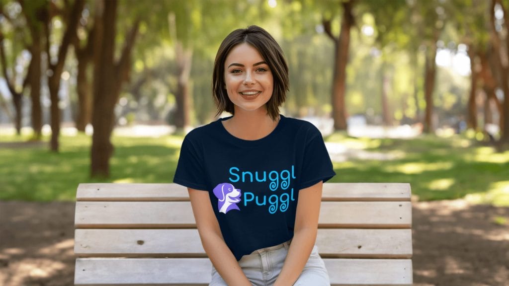 Pretty short-haired SnugglPuggl model on park bench